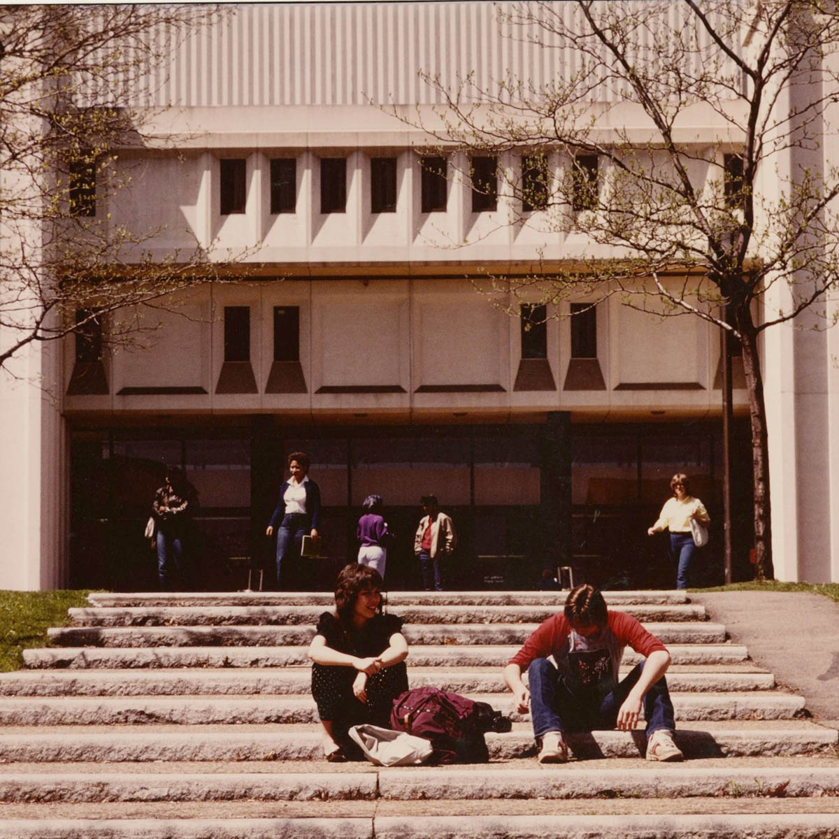 Vintage photograph from Chatham University archives of students circa 1970s seated on the steps of JKM Library