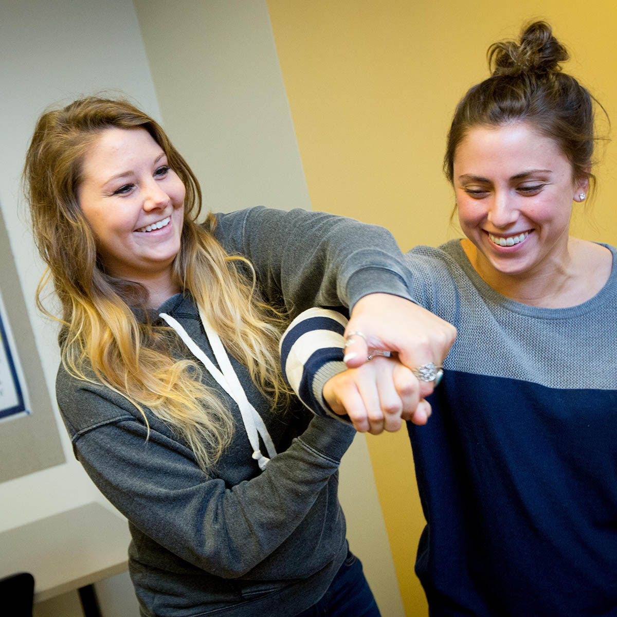 Photo of two occupational therapy students smiling and working together