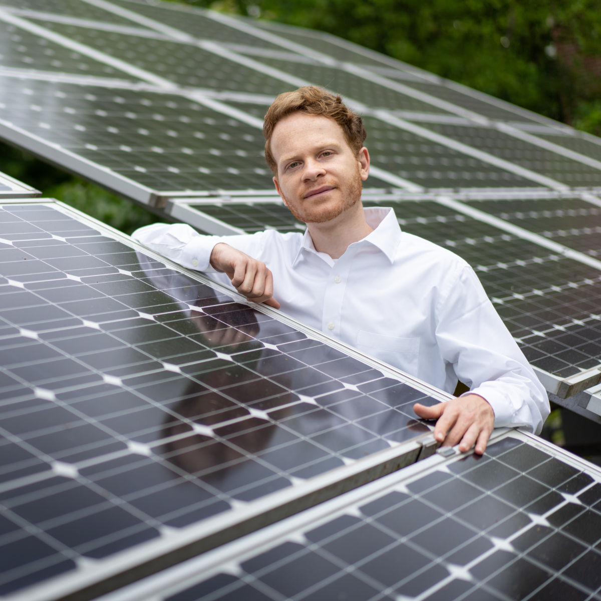 Morgan Block, MSUS poses by solar panels in Pennsylvania