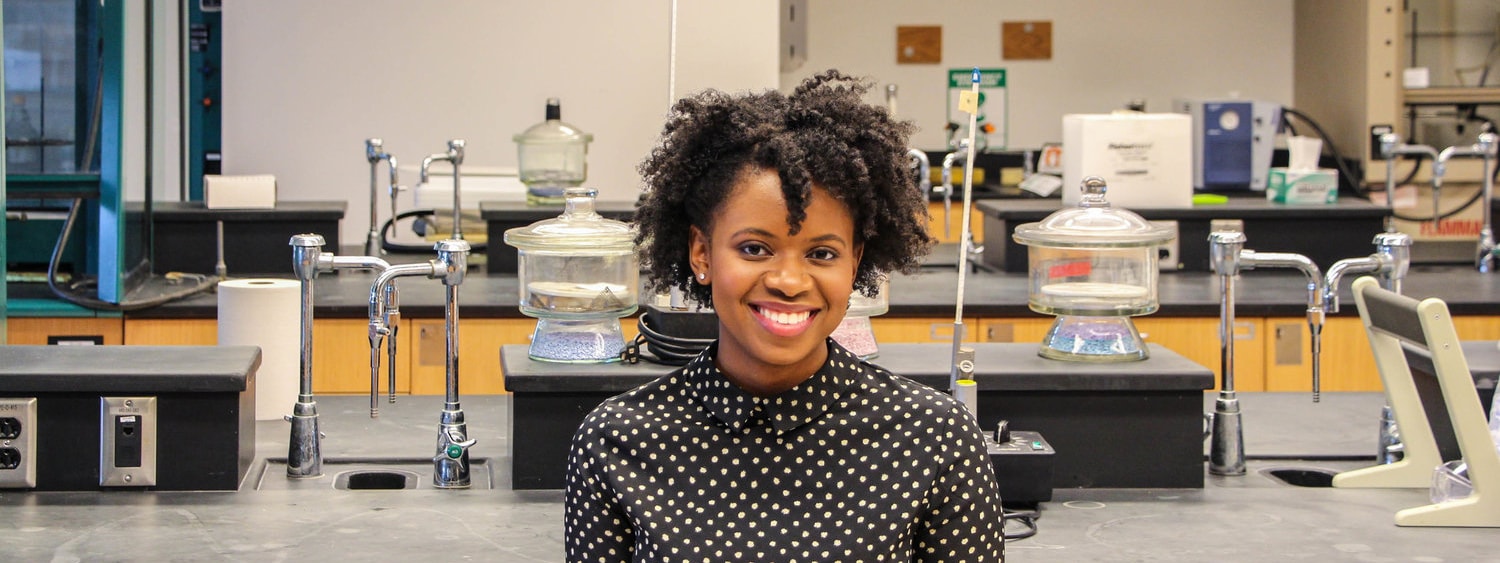 Photo of Chatham University alumane, Christina Austin, smiling in a laboratory.