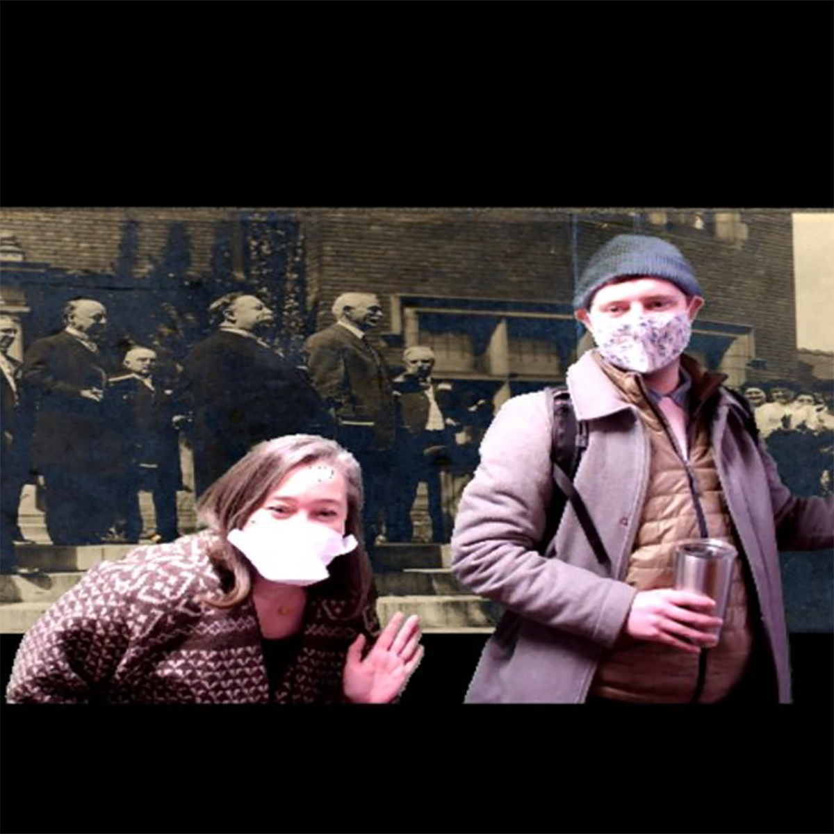 Photo of two students in masks posing in front of a historical photograph