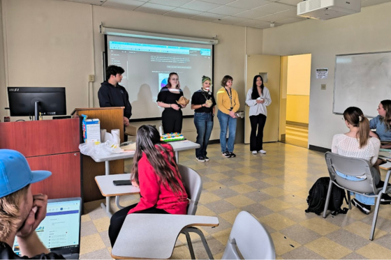 Photo of four Chatham University students walking out of Jennie Mellon King Library together. 