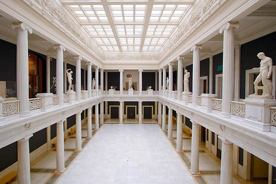 Photo of the Hall of Statues at Carnegie Museum of Art, an ornate room with white columns and statues