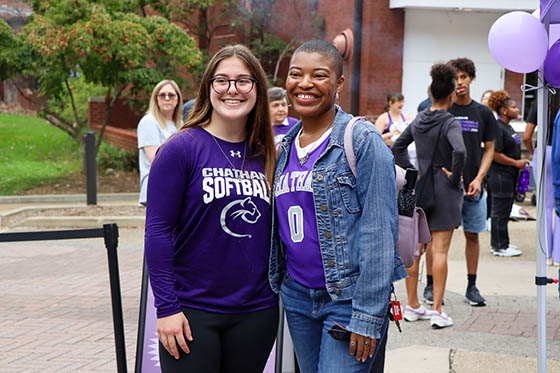 Photo of a group of alumni smiling and holding awards