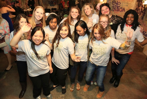 Photo of a group of young women in Chatham University Alumni t-shirts, posing for the camera