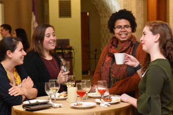Photo of four young women chatting at a Chatham University alumni event