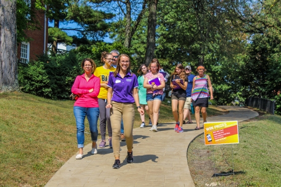 Photo of a Chatham University student giving a tour to a group of people on Shadyside Campus