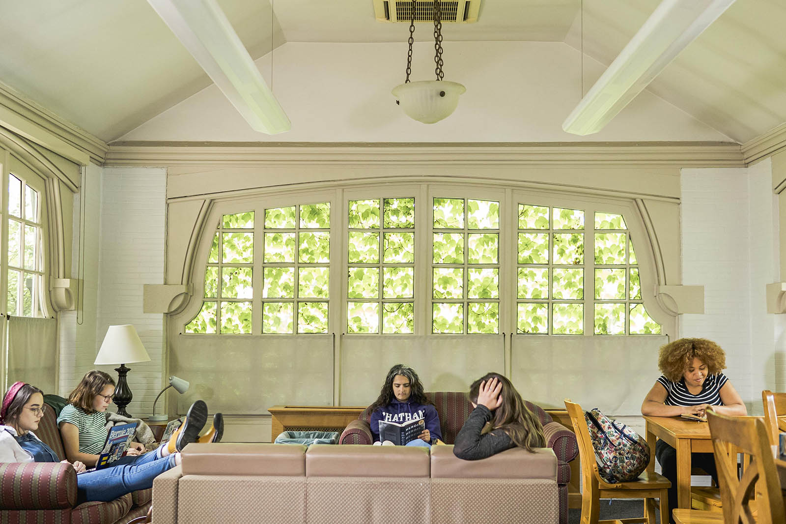 Photo of students sitting inside a residence hall study room on Chatham University's Shadyside Campus