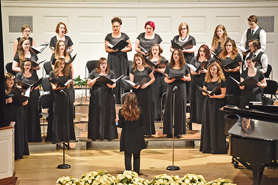 Photo of the Chatham Choir in formalwear, performing at Candlelight in the Chapel